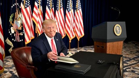 Trump smiles while signing order